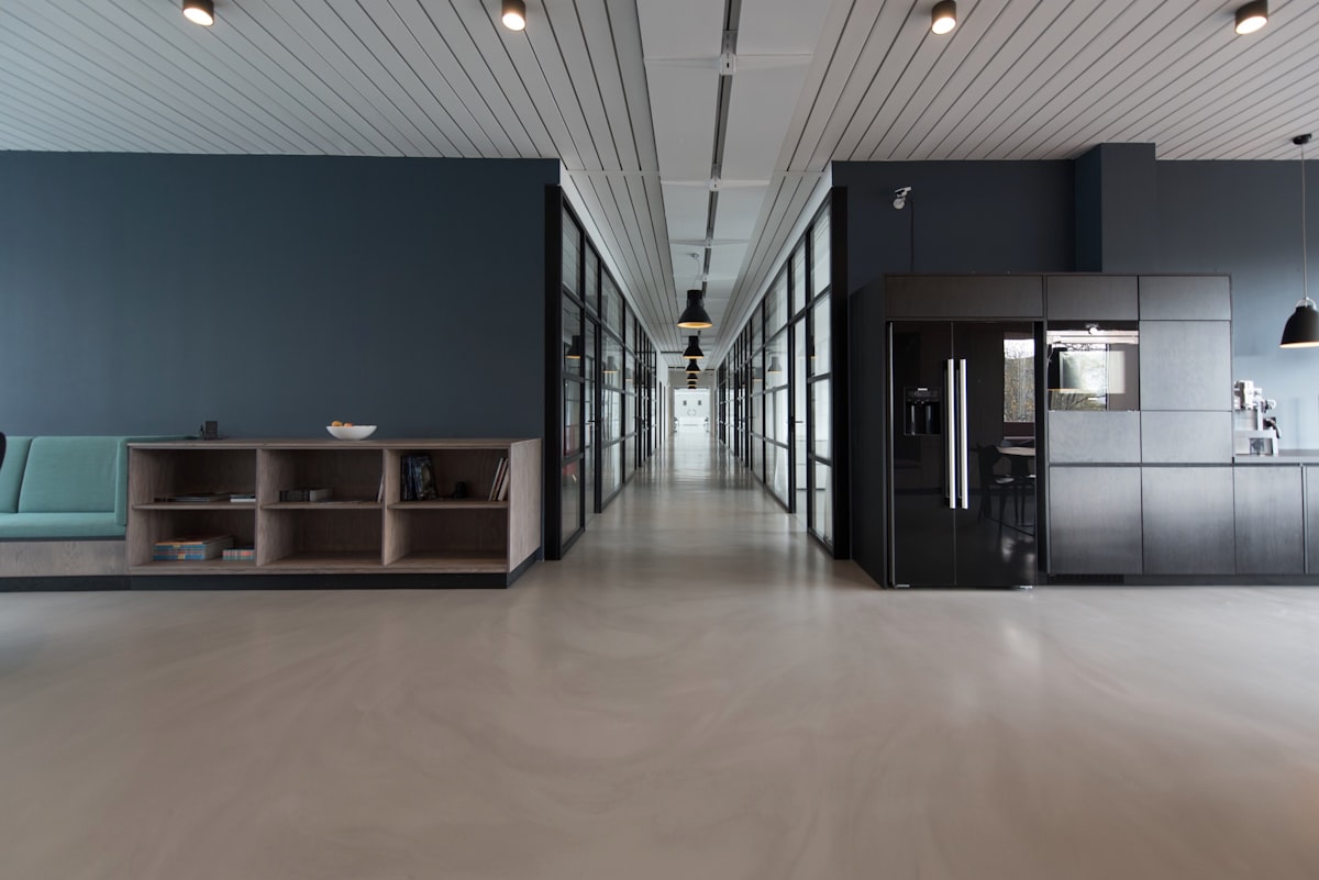 Dark premium modern corporate architecture interior, smooth minimalist office environment, velvet blue and bronze lighting setup, luxury aesthetic, no people